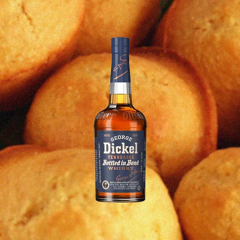 Bottle of George Dickel Bottled In Bond Whisky over backdrop of oranges.