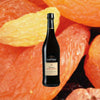 750ml bottle of Lustau Don Nuno Oloroso Dry Sherry over backdrop of dried peaches.