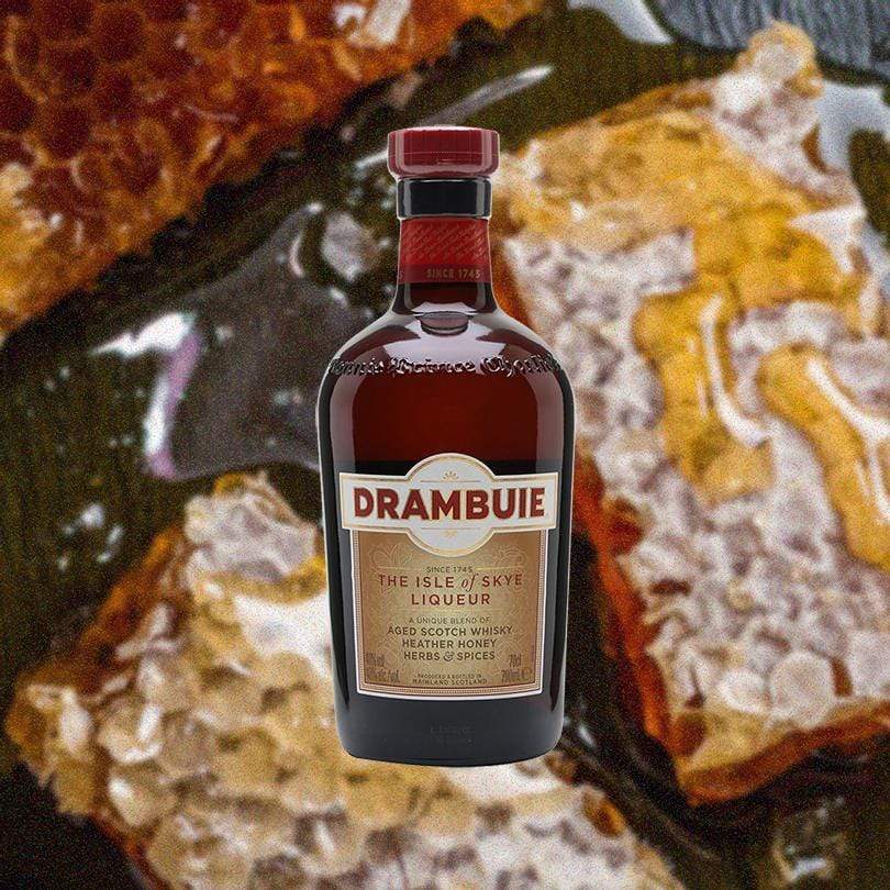 Bottle of Drambuie Liqueur over blurred background of honeycomb.