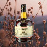 Bottle of El Dorado 15 Year Old Rum over backdrop image of flowers