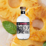 Bottle of Espolon Tequila Blanco over backdrop of peach rings.
