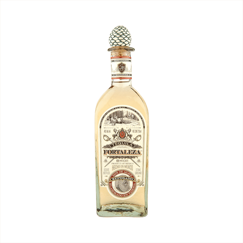 Bottle of Fortaleza Tequila Reposado the label is vintage with red details. The top of the bottle has the signature agave cork topper.