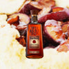 750ml bottle of Four Roses Single Barrel Bourbon over backdrop of figs and vanilla ice cream.