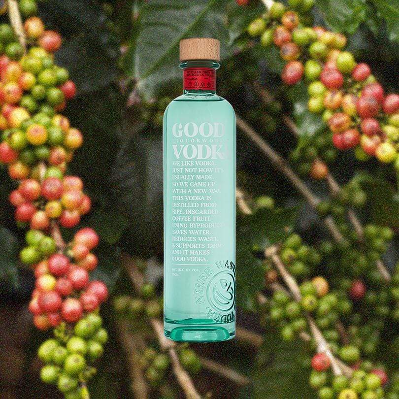 Bottle of Good Vodka over a backdrop of leaves and yellow, green and red berries.