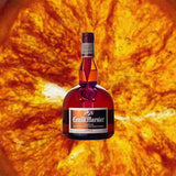 Bottle of Grand Marnier over deep orange back drop.