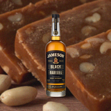 750ml bottle of Jameson Black Barrel Irish Whiskey over backdrop of pieces of dark fudge.