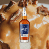 Bottle of Blue Note Juke Joint Whiskey over backdrop of decadent pastry.