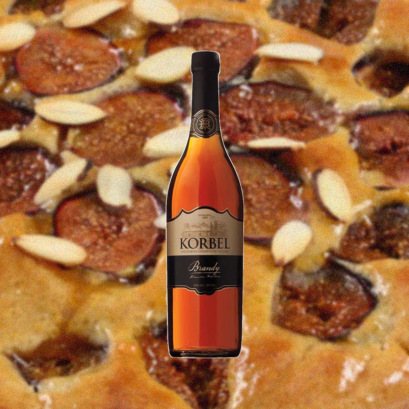 Bottle of Korbel Brandy over backdrop of pecan pie.