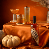 Bottle of Lot 40 Canadian Rye on an orange tablescape with a pumpkin and cocktails.