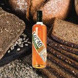 Bottle of Lot 40 Canadian Rye over backdrop of breads.