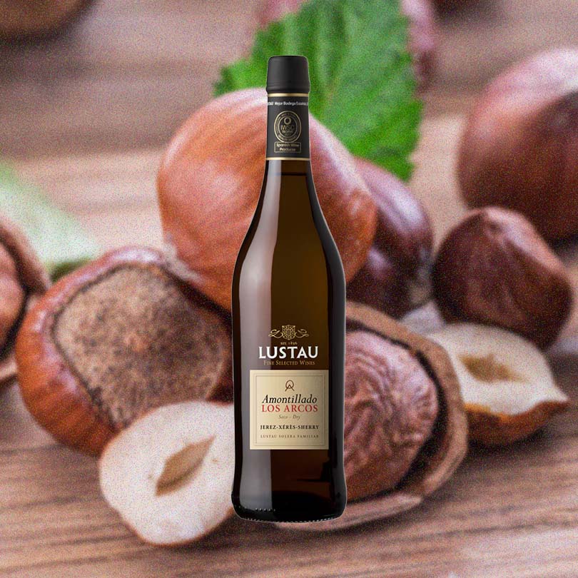 Bottle of Lustau Dry Amontillado Los Arcos over background image of cracked nuts.