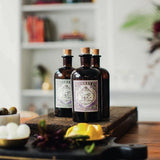 Three bottles of Monkey 47 gin on a coffee table in a cozy home.