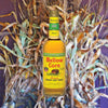 Bottle of Mellow Corn Whiskey over a backdrop of corn stalks. .