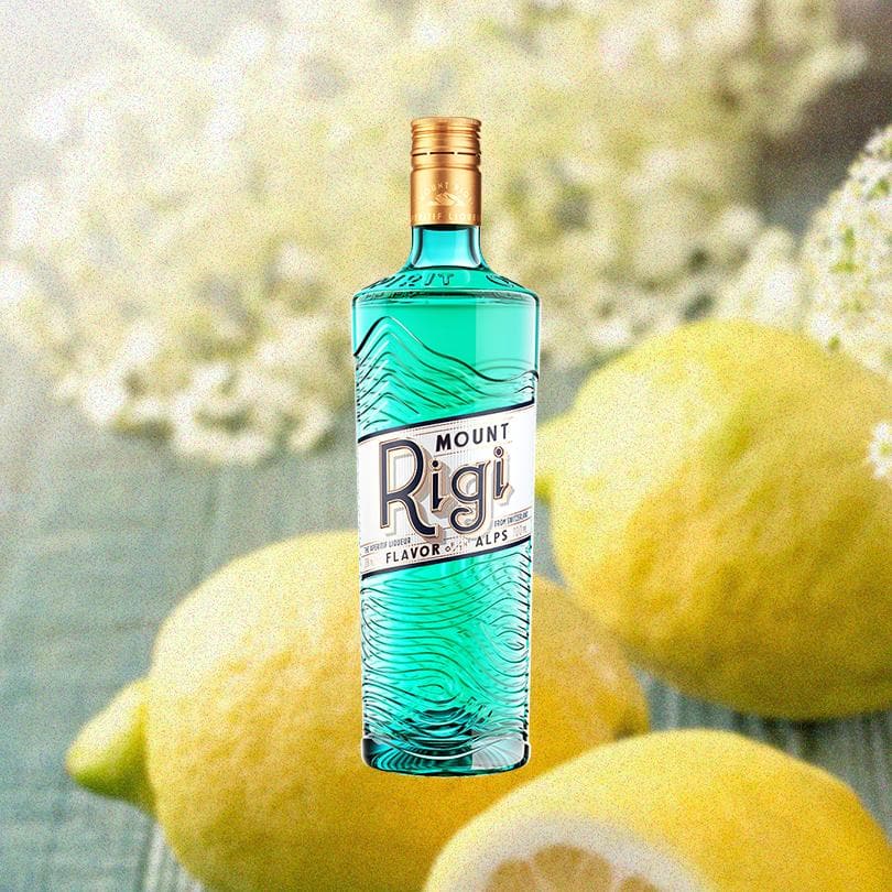 Bottle of Mount Rigi Swiss Aperitif over backdrop of 3 lemons.
