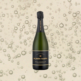 Bottle of Mumm Napa Brut Prestige, over close-up background of sparkling wine.