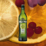 Bottle of Noilly Prat Original Dry Vermouth over backdrop of fruit.