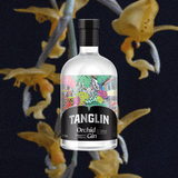 Bottle of Tanglin Orchid Gin over backdrop image of yellow flowers and a dark background.