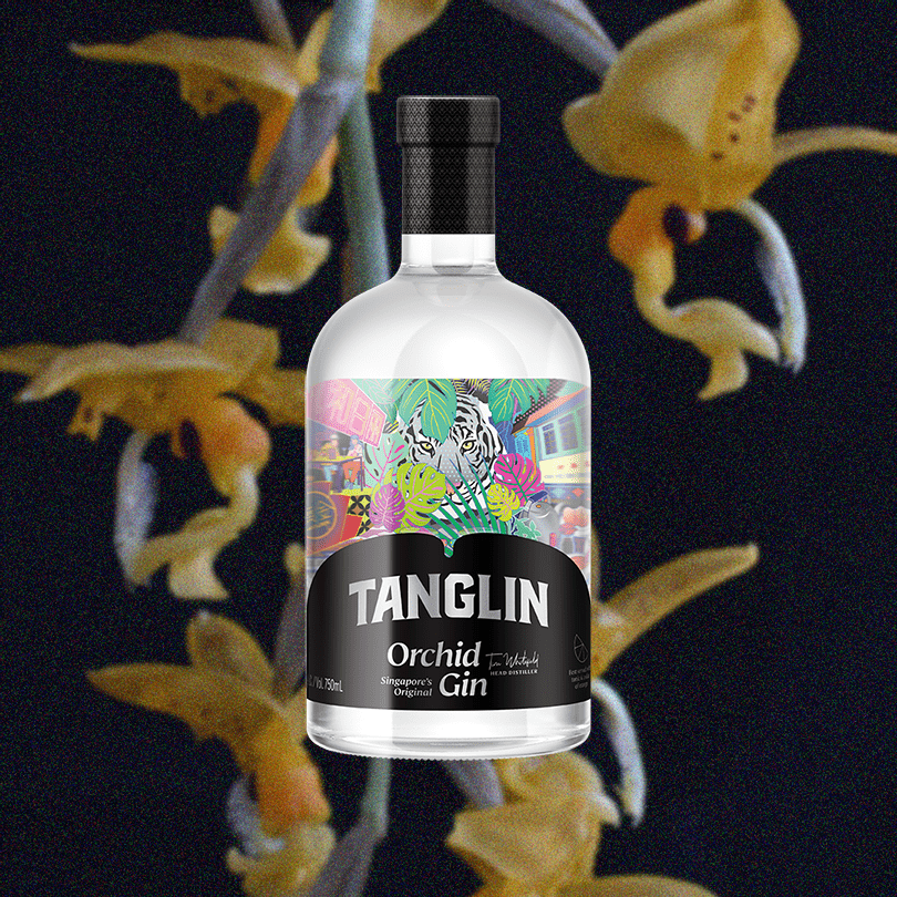 Bottle of Tanglin Orchid Gin over backdrop image of yellow flowers and a dark background.