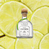 Bottle of Patron Silver Tequila over a backdrop of sliced limes.