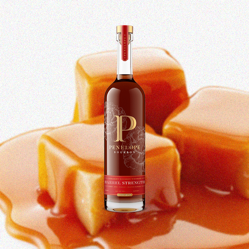 Bottle of Penelope Bourbon Barrel Strength over a backdrop of delicious looking caramel.