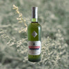 Bottle of Pernod Absinthe over light green backdrop.