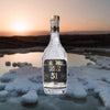 Bottle of Purity Organic Vodka Connoisseur 51 Reserve over backdrop of glacier.