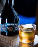 R.L. Seale’s Finest Barbados 12 Year Rum on a table next to a cocktail.