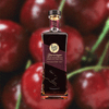 Bottle of Rabbit Hole Dareringer Bourbon with blurred close-up background of whole cherries.