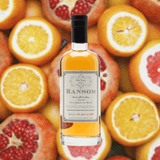 Bottle of Ransom Old Tom Gin over a background of fruit.