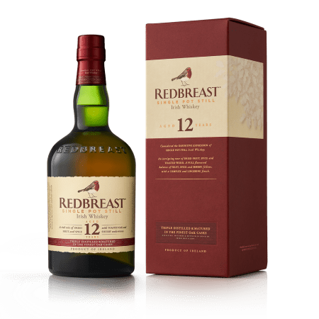 Bottle of Redbreast 12 Year Irish Whiskey next to red and white box the bottle is packaged in