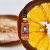 Bottle of Regans' Orange Bitters over background of orange slices.