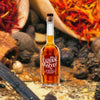 Bottle of Sazerac Straight Rye Whiskey over close-up backdrop of chilis and spices.