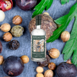 Bottle of Bottle of Sipsmith London Dry Gin over backdrop of blueberries, nuts, leaves, and spices.