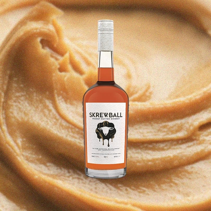 Bottle of Skrewball Peanut Butter Whiskey. Backdrop of Peanut Butter.
