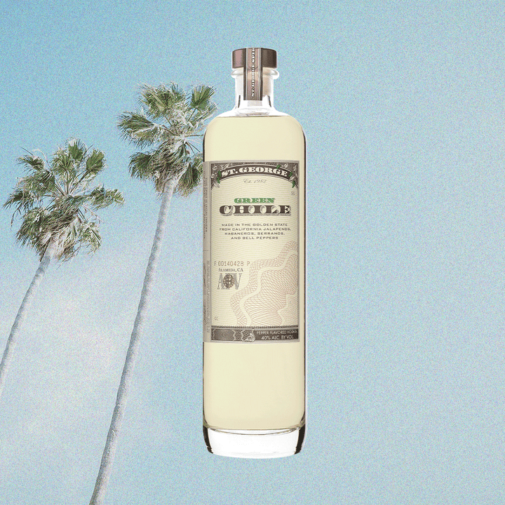 Bottle image of St. George Green Chili Vodka. Background image of palm tree and blue sky. 