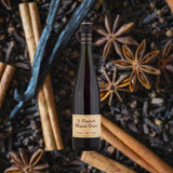 Bottle of St. Elizabeth Allspice Dram over backdrop of spices.