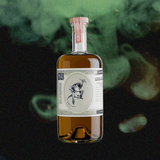 Bottle of St. George Absinthe Verte over a dark smoky green backdrop.