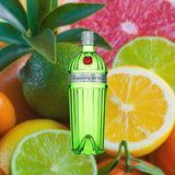 Bottle of Tanqueray No. Ten Gin, over close-up background of various citrus fruits.
