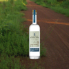 Tequila Ocho Plata over back drop of country road.