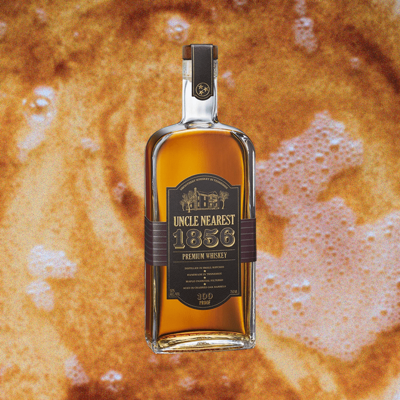 Bottle of Uncle Nearest 1856 Premium Aged Whiskey over what looks like light soda.