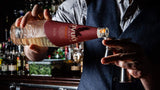 Image of bartender pouring Avua Amburana Cachaca into a jigger.