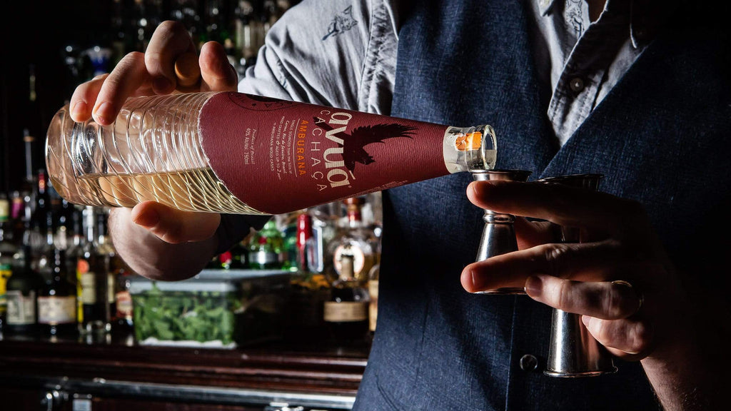 Image of bartender pouring Avua Amburana Cachaca into a jigger.
