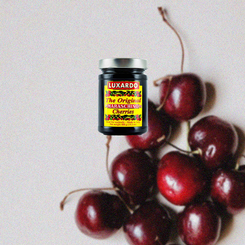 Luxardo Maraschino Cherries Jar. Backdrop of cherries.