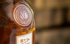 Emblem imprinted on Courage & Conviction Whisky bottle.