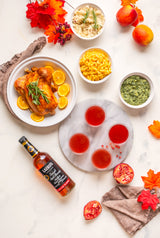 Laird's Straight Apple Brandy 100 Proof Bottled In Bond on a table with fall style foods and drinks.