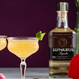 Bottle of Lunazul Reposado Tequila next to cocktail glass.